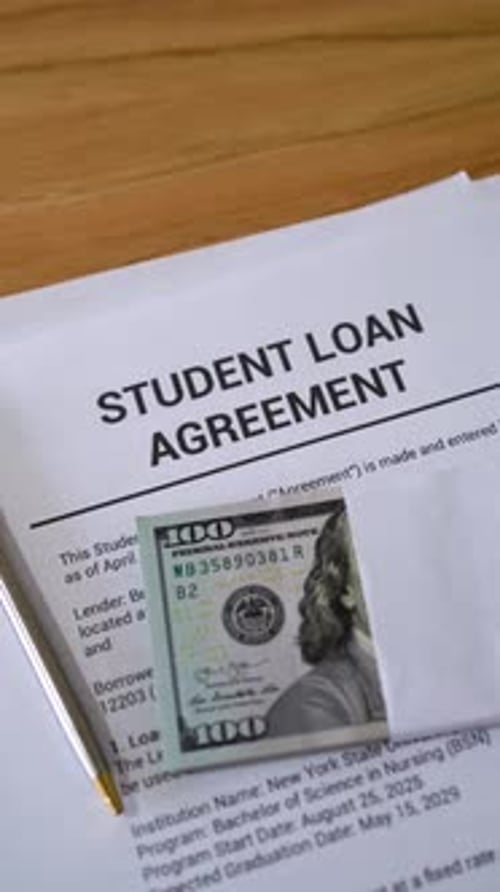 Student loan concept. Vertical shot of loan agreement documents.