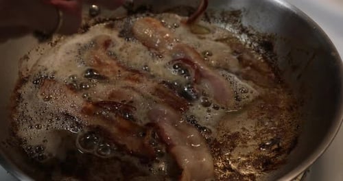 Bacon Sizzles and Fries in Silver Pan