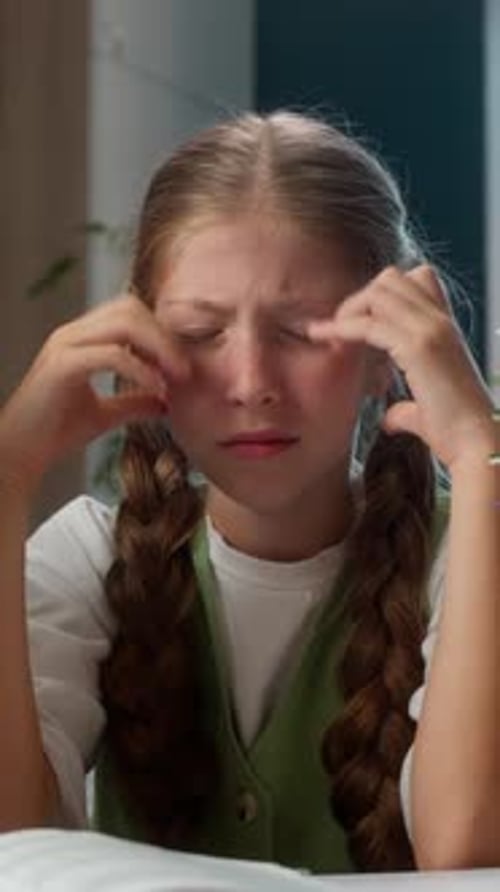 Frustrated Caucasian Little Girl Kid Child Looking at Many Books on Table Feeling Stress Holding
