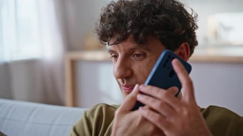 Man Talking on Smartphone Indoors Close Up