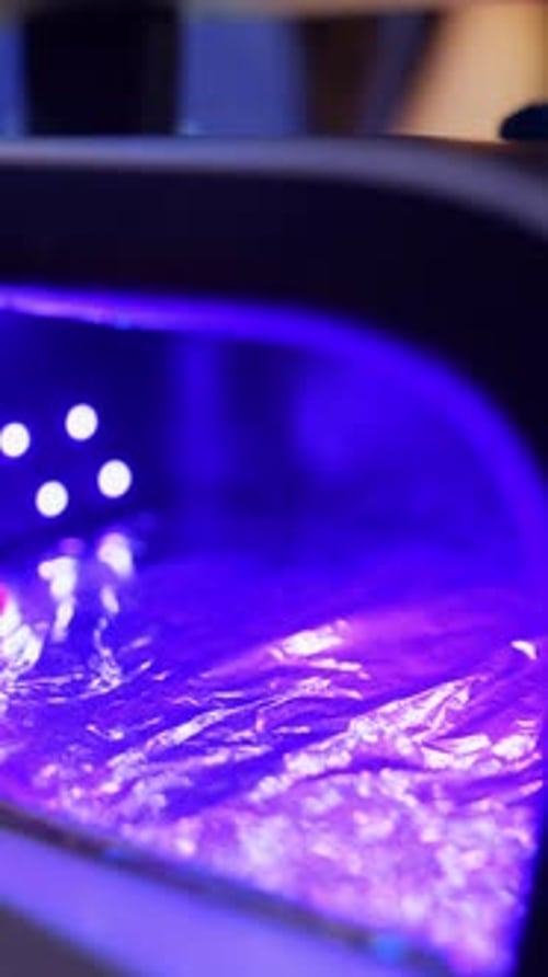 Woman's Hand Manicured Under UV Light