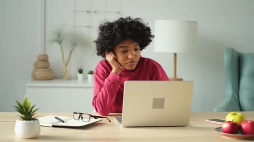 African American Girl Using Laptop at Home Office Looking at Screen Typing Chatting Reading Writing