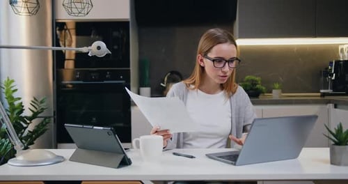 Caucasian businesswoman working with papers in home office woman read loan invoice document