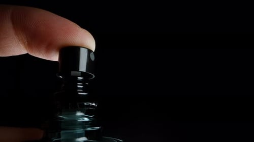 Finger Presses Spray Bottle Pump in Macro Shot