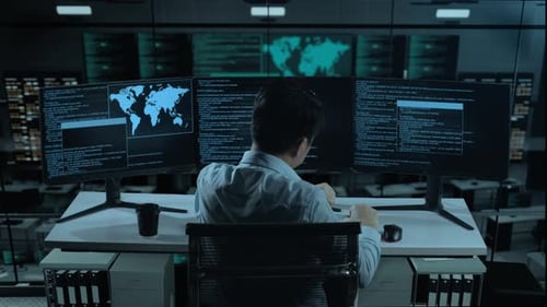 Back View Of Tired Asian Man Stretching While Write Code With Multiple Computer Screens In office