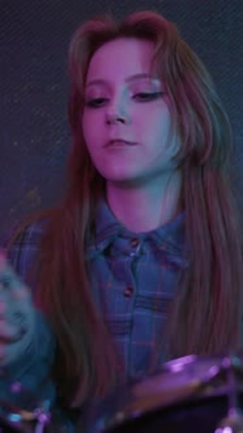 Cute Young Woman Playing Drums in the Sound Recording Studio