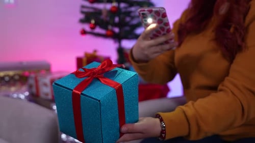 Woman Taking Photo of Gift on Christmas