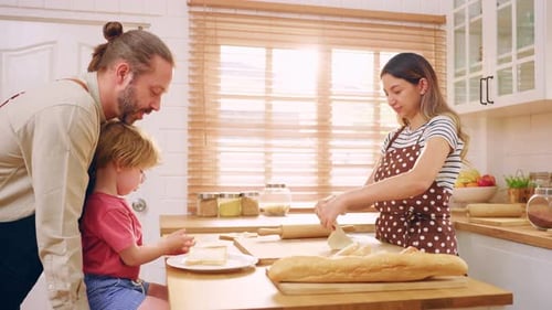 Caucasian attractive couple baking bakery with son in kitchen at home.