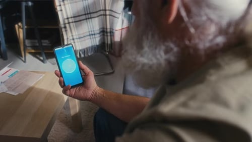 Senior Adult Monitoring Glucose on Mobile Device