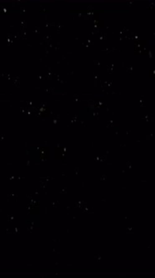 Light Particles Rising on Black Background Abstract