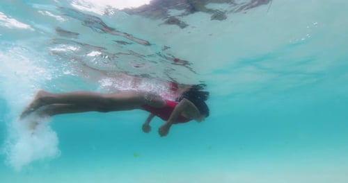 Woman Swims and Snorkeling on Shallow Water in Blue Ocean