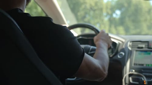 Close Up of Man Driving Car in City