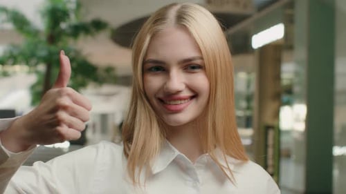 Smiling Blond Woman Gives Thumbs Up Gesture
