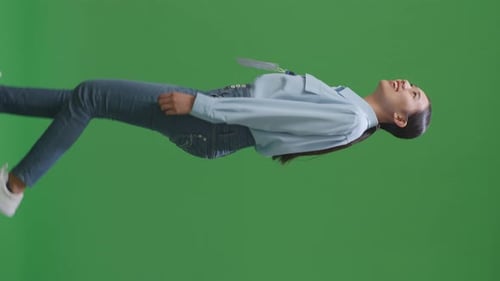 Side View Of Asian Business Woman Walking On Green Screen Background In The Studio