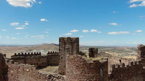 flight in a ruined castle with its walls and towers seeing the main tower with a panning of the came