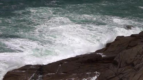 High Waves Crashing Against the Rocky Shoreline