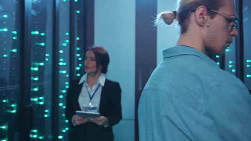 Technicians Working with Servers in Data Center