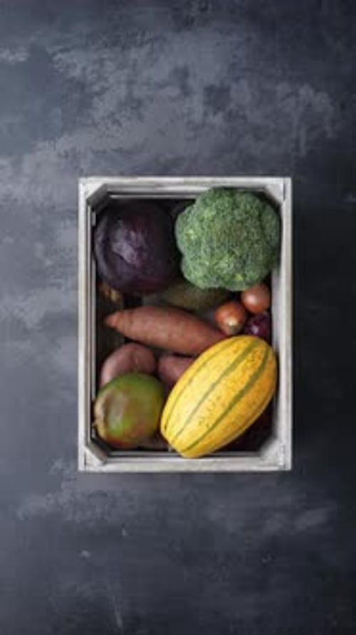 Fresh Vegetables and Fruits Filling a Wooden Crate