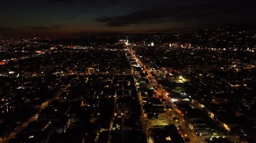 Aerial Panoramic Footage of Night City Fly Above Urban Borough Traffic on Lighted Boulevard