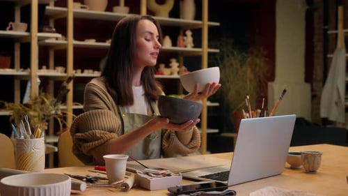 Woman Potter Craftswoman Holding Two Handmade Bowls in Pottery Workshop Caucasian Girl Female
