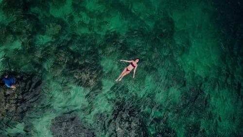 Woman Floating in Clear Emerald Water, Tropical Holiday