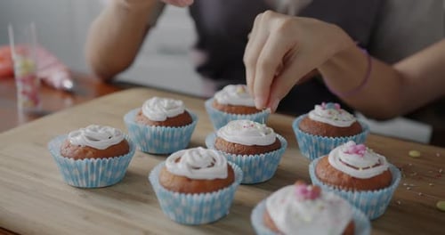 Decorating Cupcakes with Frosting and Sprinkles