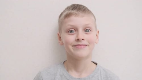 Blonde Boy Smiling Intently Close Up