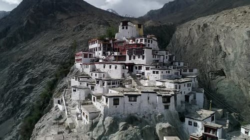 aerial view of an ancient remains of buddhist monastery on a rocky mountain.camera moving vertically