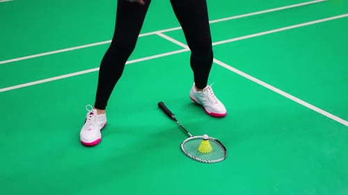 Sports Young Woman with Racket and Shuttlecock is Exercising Doing Warmup Before Playing in