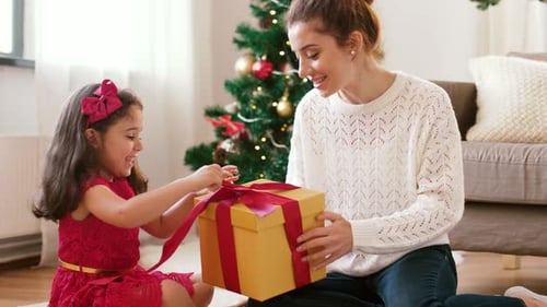 Mother and Daughter Opening Christmas Gift Together