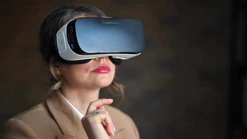 Woman gesturing while using a Virtual Reality headset in an office