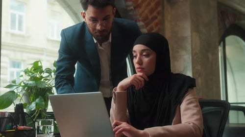 Two Professionals Business Team Cooperation in Office with Laptop Male Businessman Teaching Female