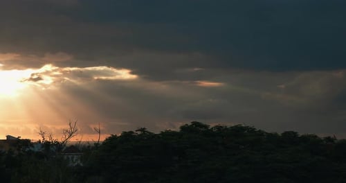 Sun Rays Burst Through Dramatic Cloudscape at Sunset