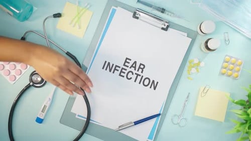 Medical Tools and Ear Infection Diagnosis on Table