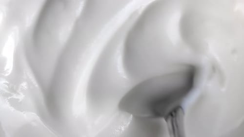 Creamy White Food Being Stirred by Spoon