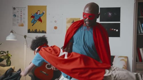 Father and Son Play Superhero in Living Room
