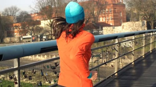 Young Woman Jogging on Bridge in City 30s