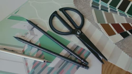 Close-up of Two Pencils, Pen and Scissors on Wooden Table of Designer