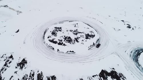 Car Drifting on Snowy Ice Track in Winter Aerial Drone View