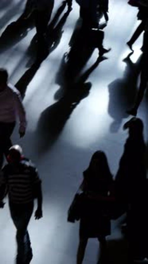 Silhouetted Figures Walking in a Modern Urban Space with a Contemporary Feel to It