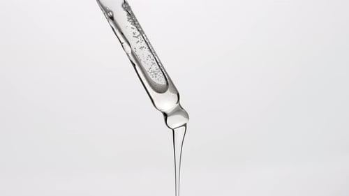 Serum Liquid Dripping From Glass Pipette
