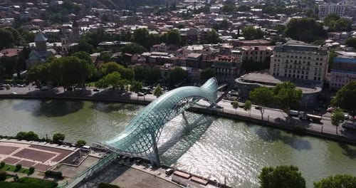 Aerial Boom Shot Above Kura River, Bridge of Peace. Tbilisi, Georgia. Summer