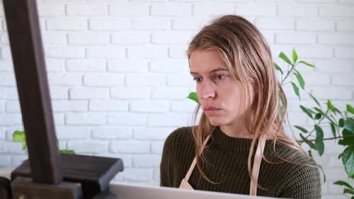Beautiful female artist painting picture in art studio.