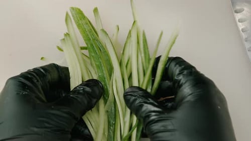 close-up of thinly sliced fresh cucumber lying on the board ingredient for sushi in the restaurant