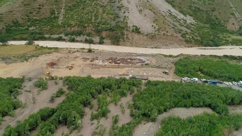 Aerial of an Excavator and Wheeled Bulldozers Removing Massive Mudflow From the Roadway Natural