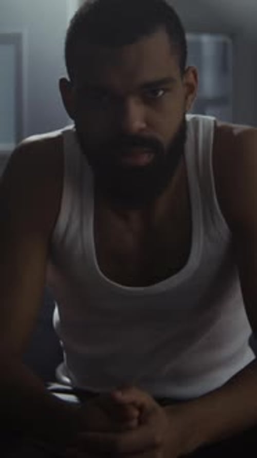 Contemplative Man Sitting with Intense Expression