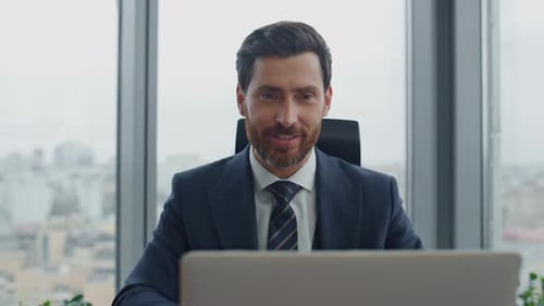 Successful Bearded Manager Have Video Negotiation on Laptop Camera Sitting Office Desk