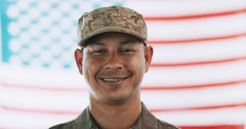 Smiling Service Member in Front of American Flag
