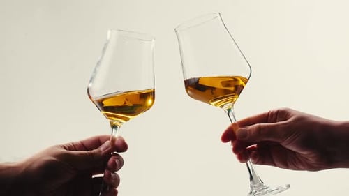 Orange or White Wine Bottle and Glass Against a Sunset in a Peaceful Vineyard Pouring of Ecological