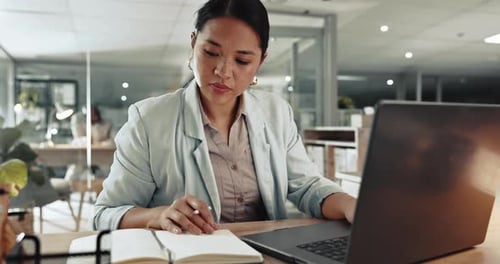 Businesswoman Working on Laptop in Bright Modern Office